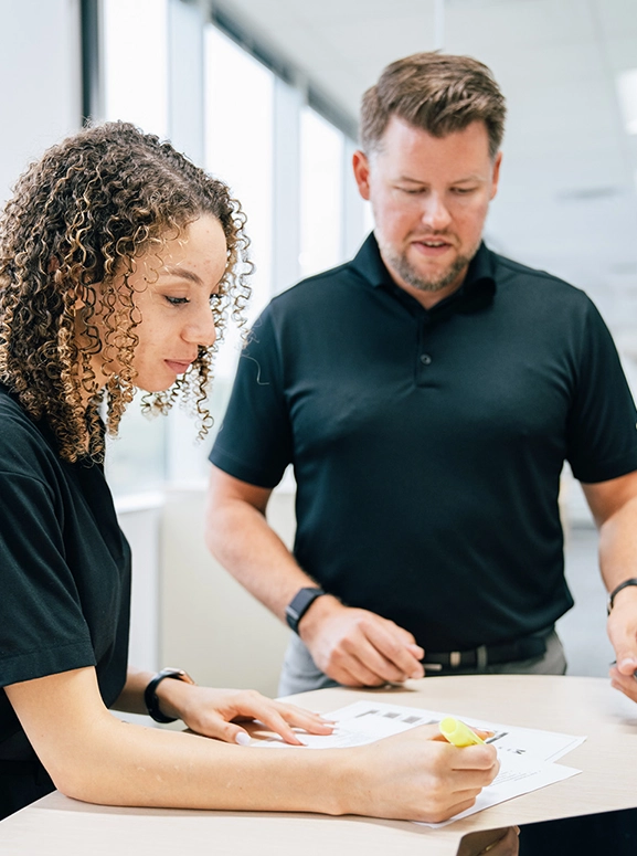 woman and man looking at forms for renting a vehicle in Indianapolis